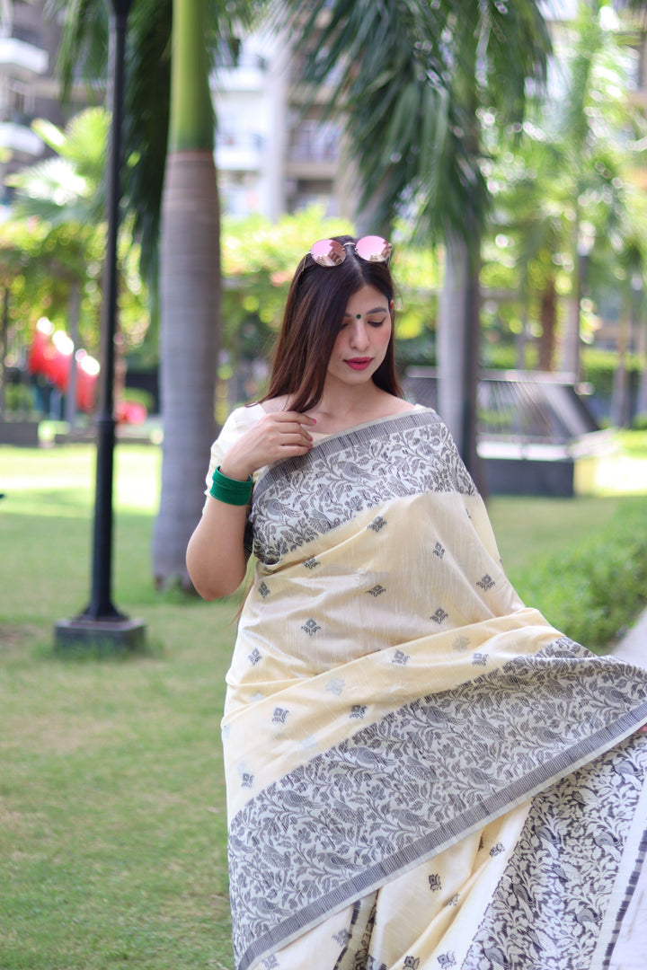 Traditional handloom raw silk saree with woven pallu and detailed butties design