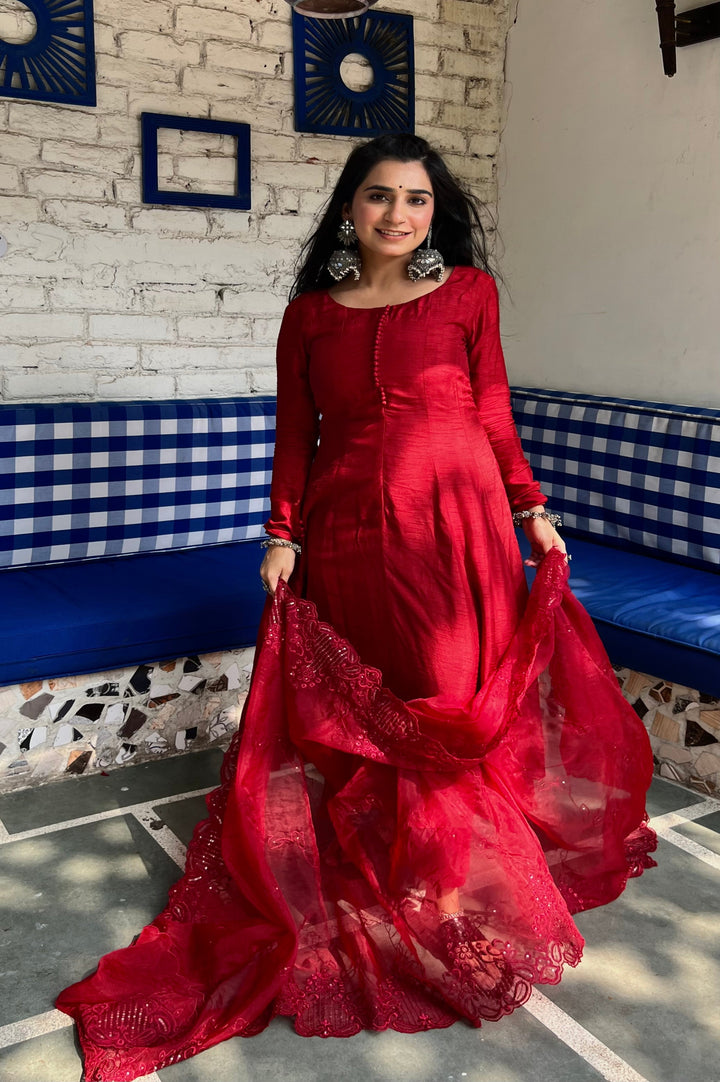 Blood red Anarkali suit set featuring stylish embroidery and a chic design, ideal for weddings and celebrations.