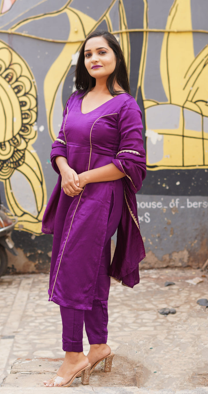 Elegant purple silk suit set paired with a lightweight chanderi dupatta, offering a regal look for events.