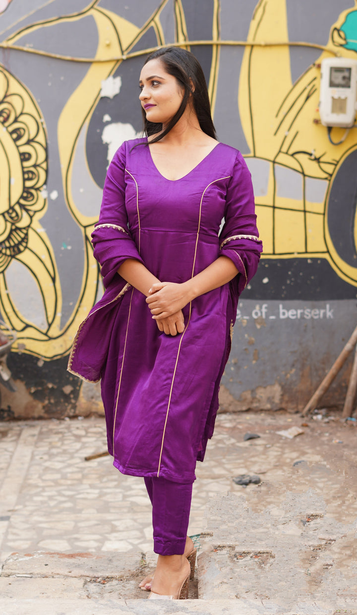 Luxurious purple suit set featuring a sophisticated silk top and a flowing chanderi dupatta for graceful draping.