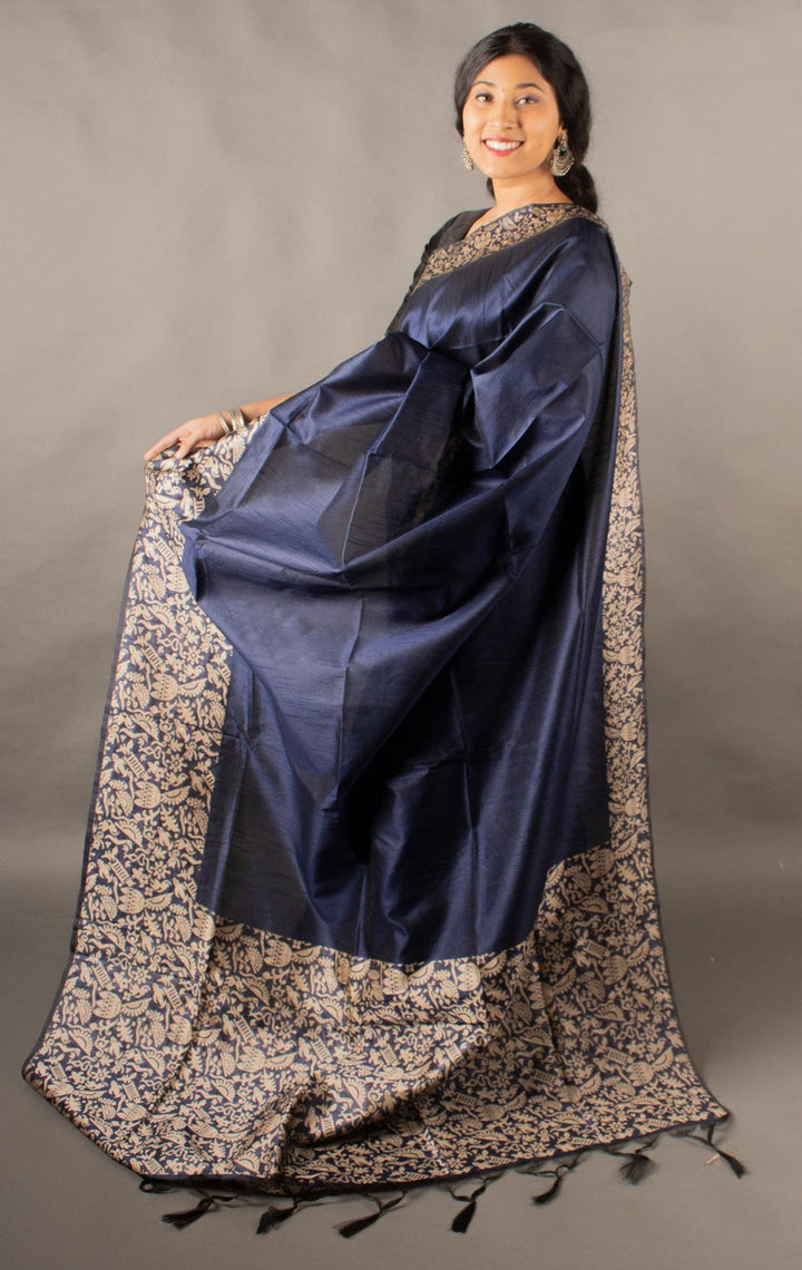 Classic navy raw silk saree with intricate pallu detailing, perfect for Indian weddings.