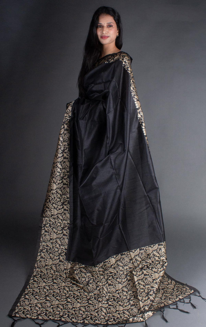 Sophisticated black raw silk saree with intricate pallu detailing, perfect for weddings.