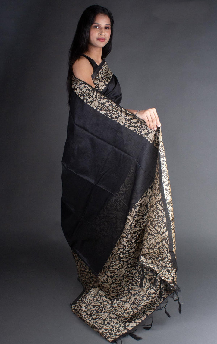 Exquisite black handloom raw silk saree with a rich pallu, perfect for grand Indian celebrations.