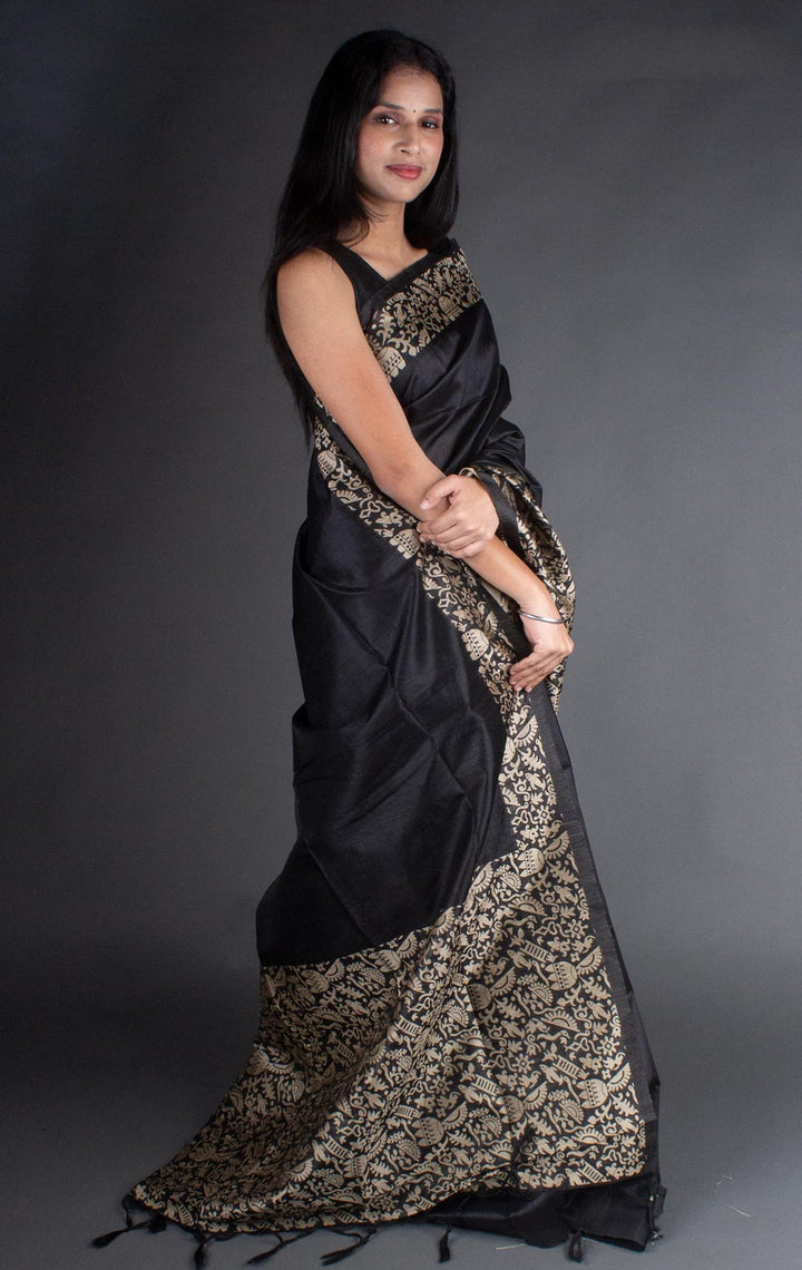 Classic black raw silk saree with beautiful pallu work, ideal for cultural events and weddings.