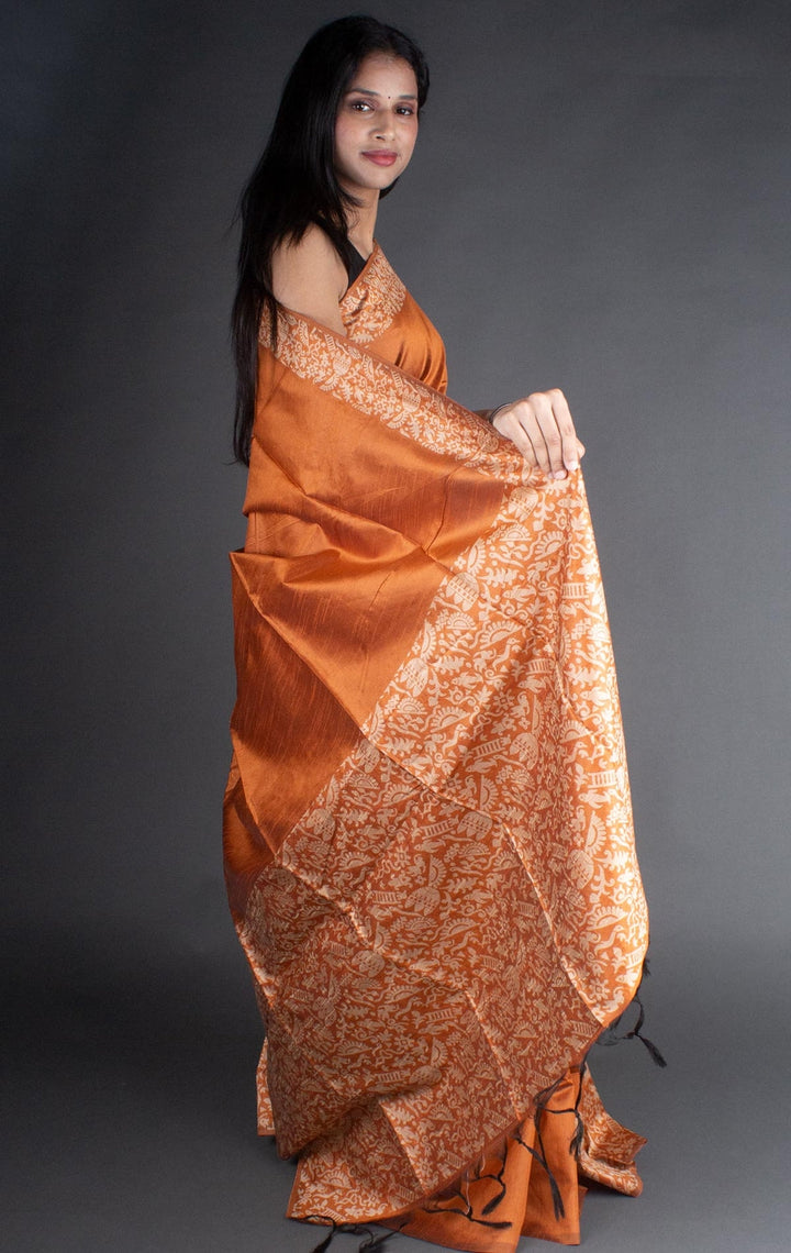 Exquisite orange raw silk saree with a rich pallu, perfect for traditional Indian ceremonies.