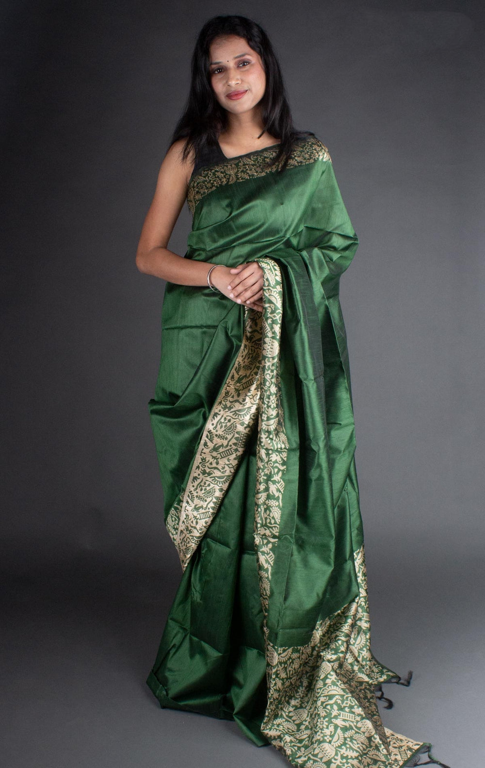 Timeless dark green raw silk saree with intricate pallu weaving, ideal for traditional events.