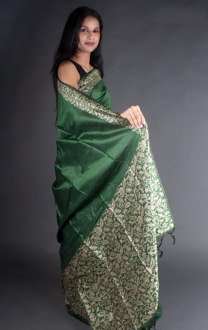 Exquisite dark green raw silk saree with a rich pallu, ideal for Indian cultural celebrations.