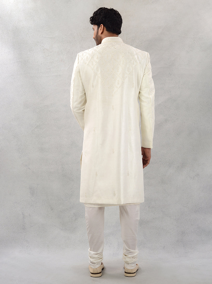 This off-white silk blend sherwani features intricate embroidery, perfect for grooms looking to make a stunning impression at their wedding celebrations.