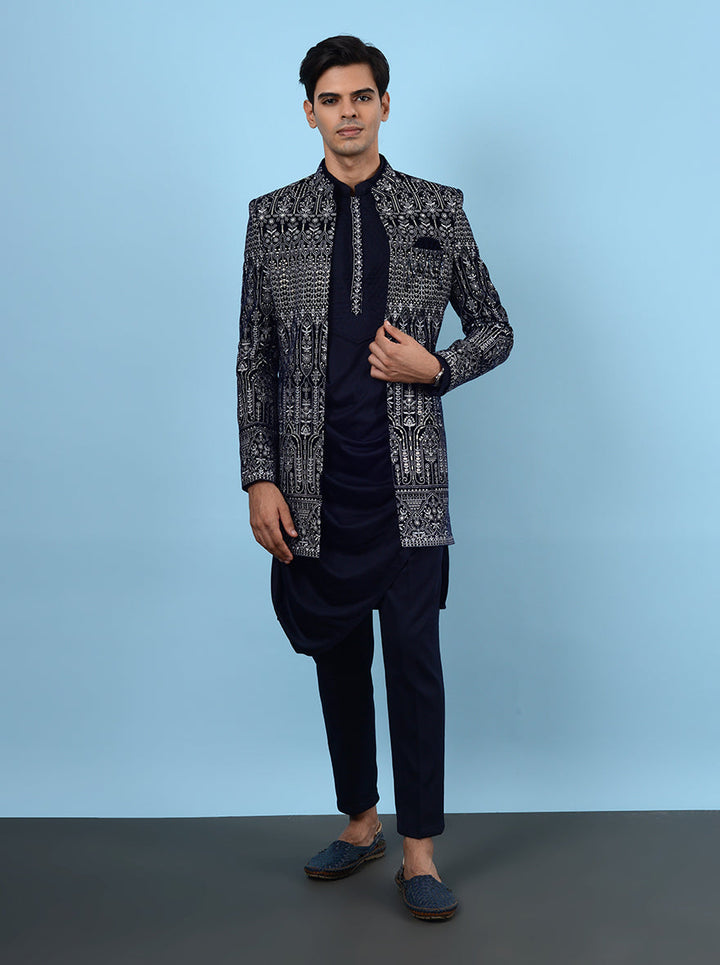 Make a grand impression at your reception in this navy blue Indowestern, designed for sangeet celebrations, featuring premium velvet and intricate embroidery for an upscale look in the USA.