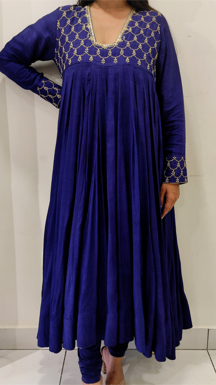 Sophisticated royal blue Anarkali in luxurious Tussar silk, showcasing intricate Aari work and a stunning dupatta.