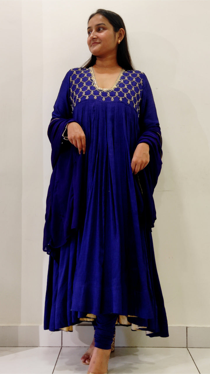 Traditional royal blue Anarkali dress crafted in Tussar silk with intricate Aari embroidery and matching dupatta.