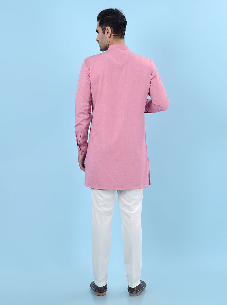 Men's pink kurta pajama set in silk blend, designed for a regular fit and ideal for traditional celebrations.