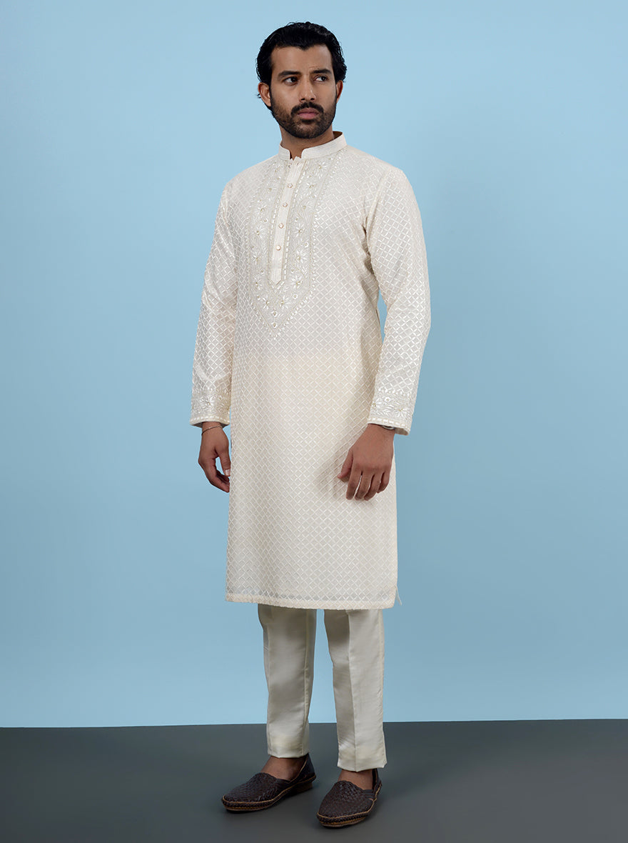 Luxurious cream kurta pajama for men’s haldi and pooja, USA-inspired, with detailed embroidery.