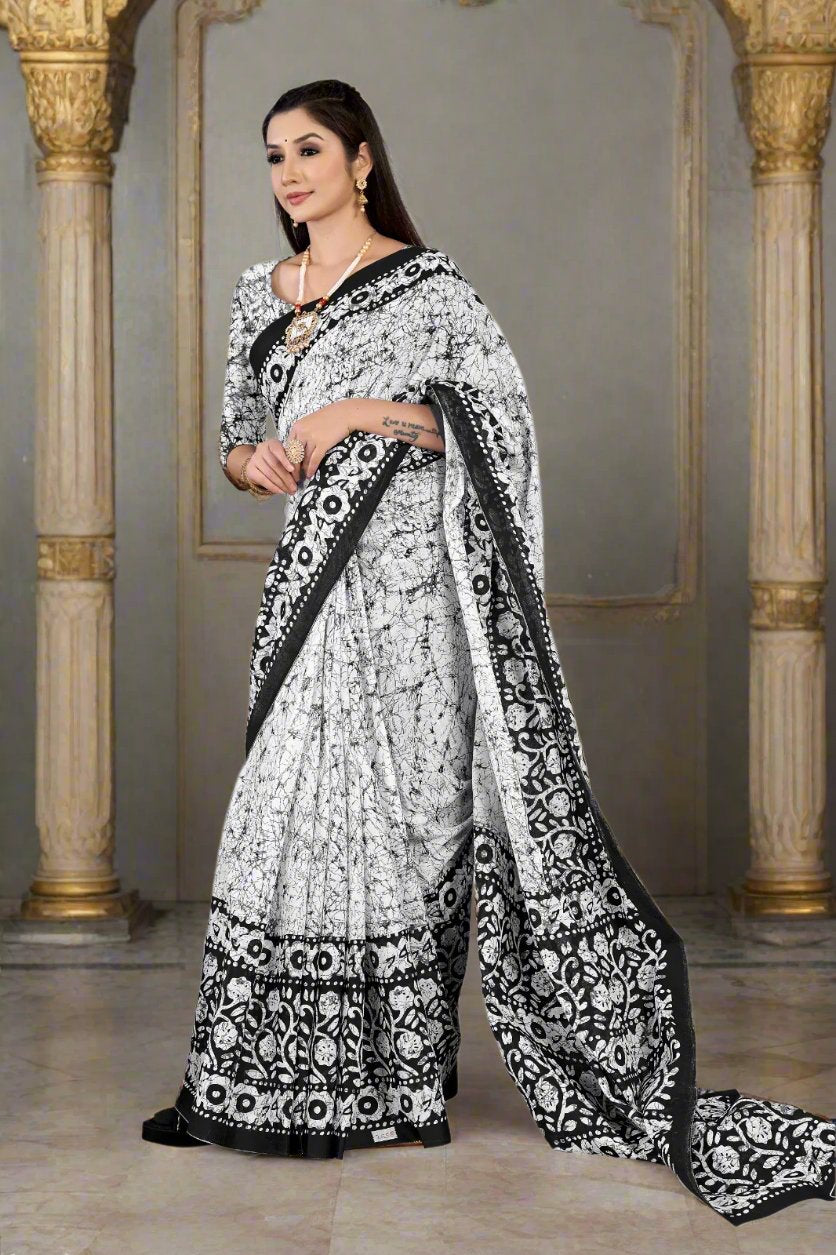 Beautiful white and black batik saree, crafted from soft cotton, perfect for traditional celebrations.