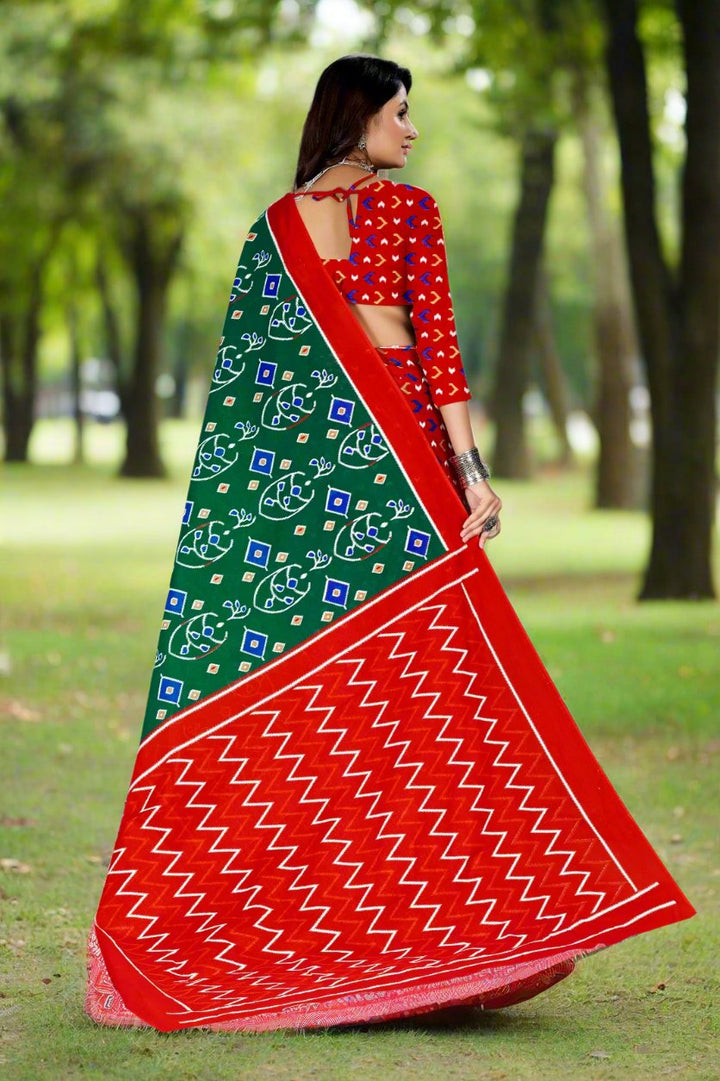 Beautiful green and red batik saree, perfect for festive occasions and weddings.