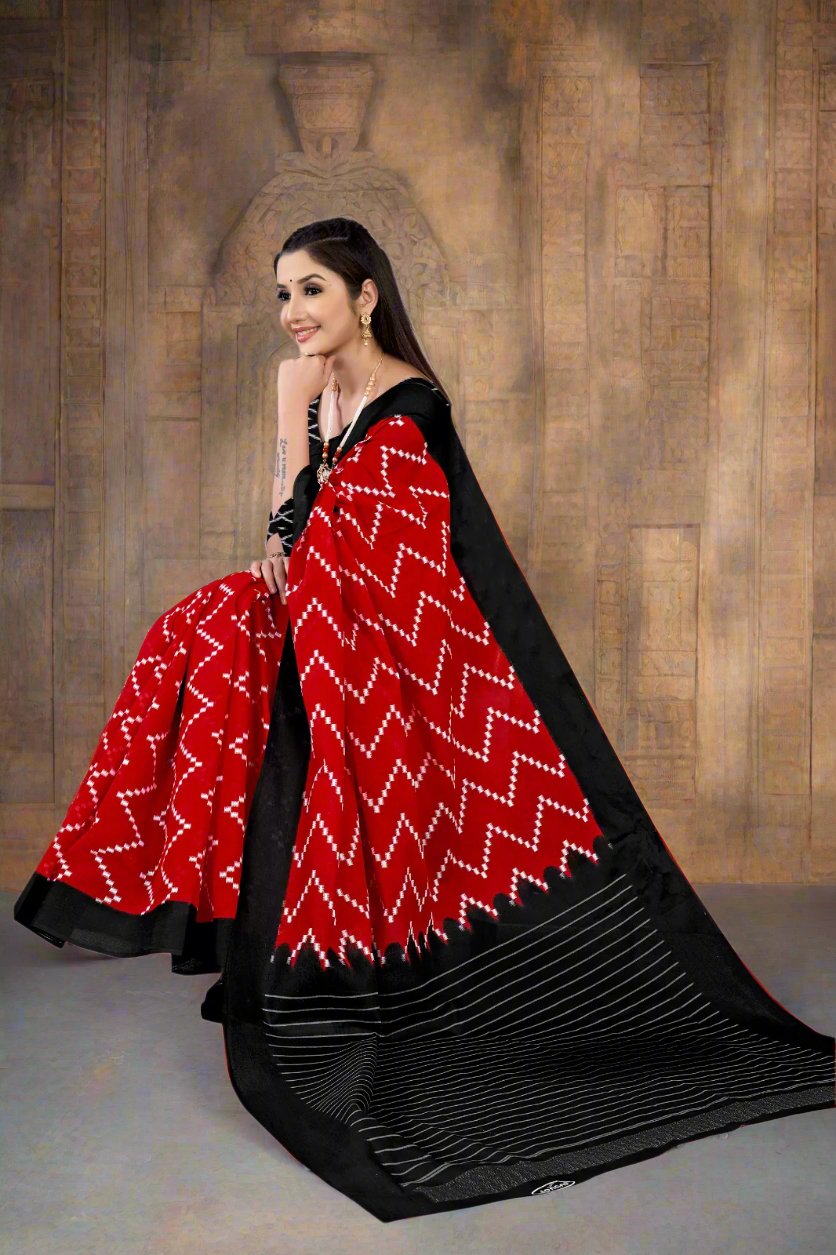 Red and black Batik cotton saree with unique prints for festive celebrations.