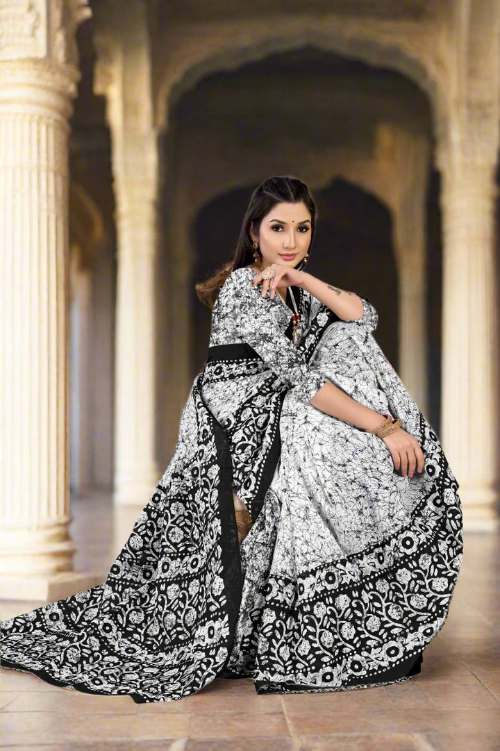 Elegant white and black saree with batik patterns, a sophisticated choice for festive occasions.