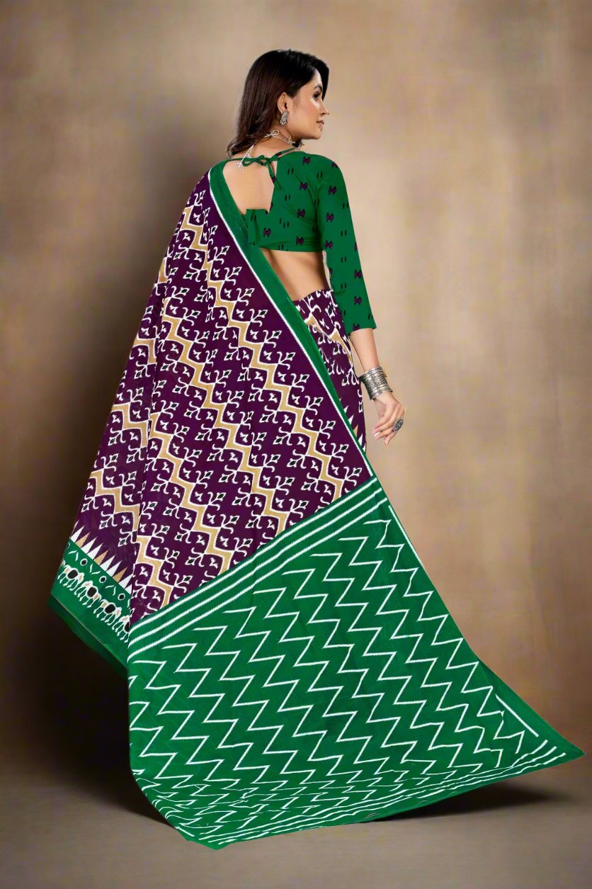 Elegant dark purple and green cotton saree with batik print, ideal for festive occasions.