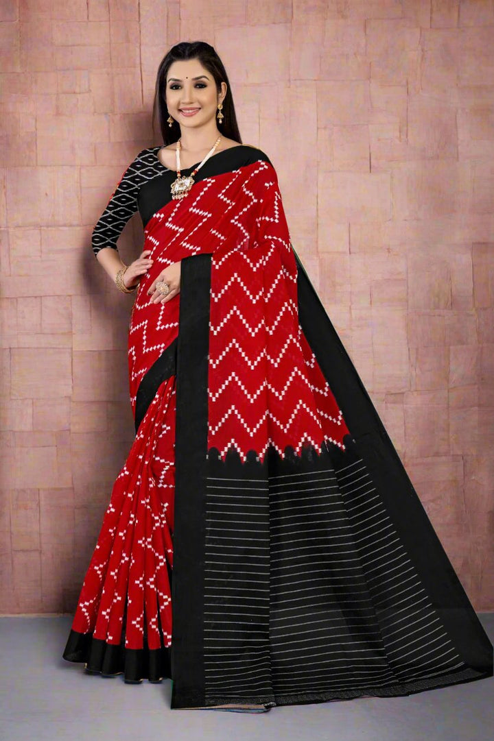 Elegant red and black Batik cotton saree with intricate designs for traditional occasions.