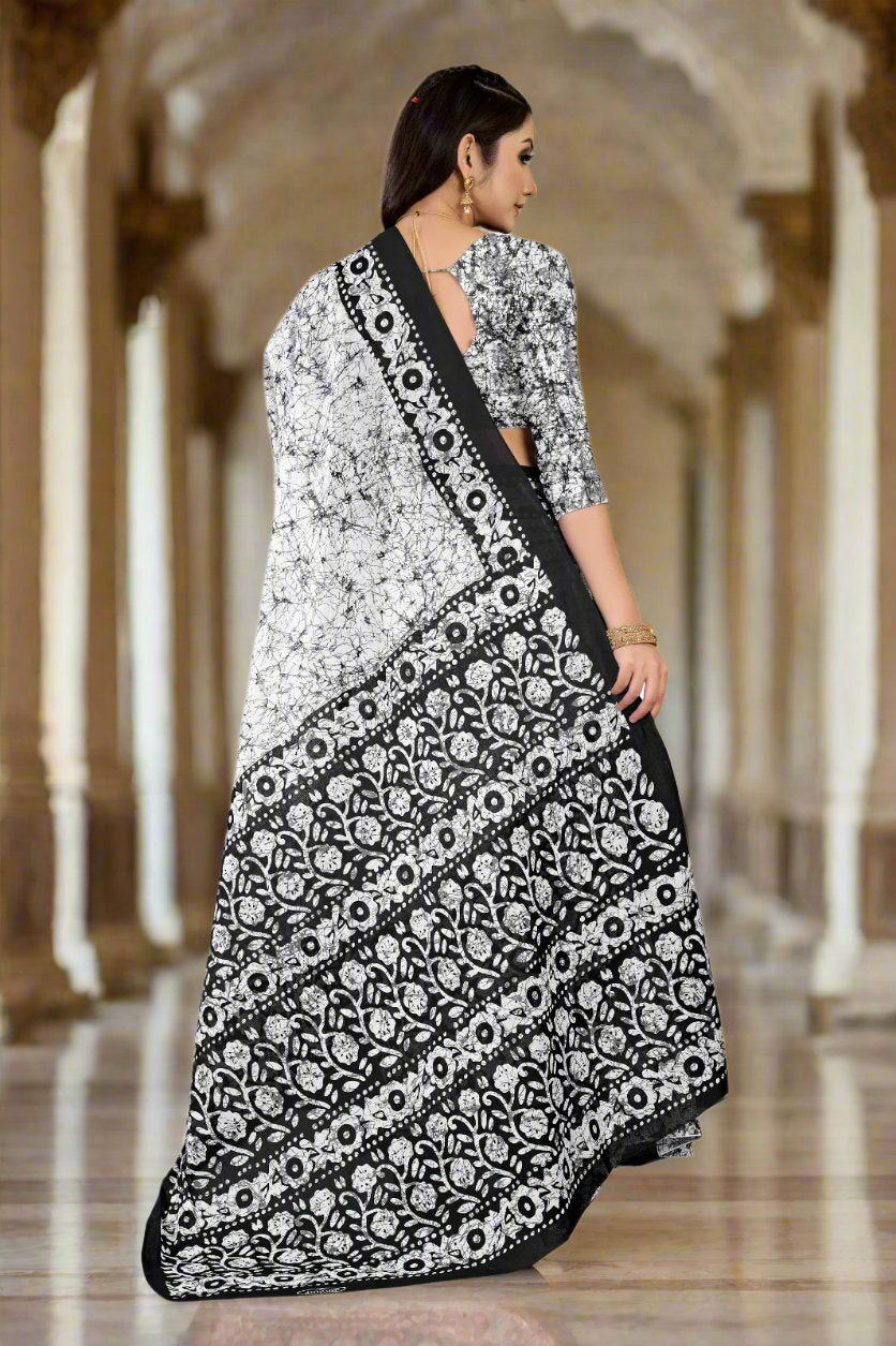 Stylish white and black saree with intricate batik designs, perfect for weddings and cultural occasions.