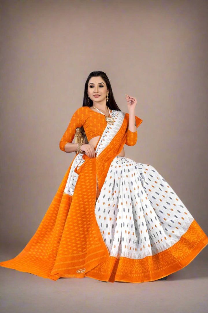 Timeless white and orange batik cotton saree, a sophisticated choice for cultural festivals.