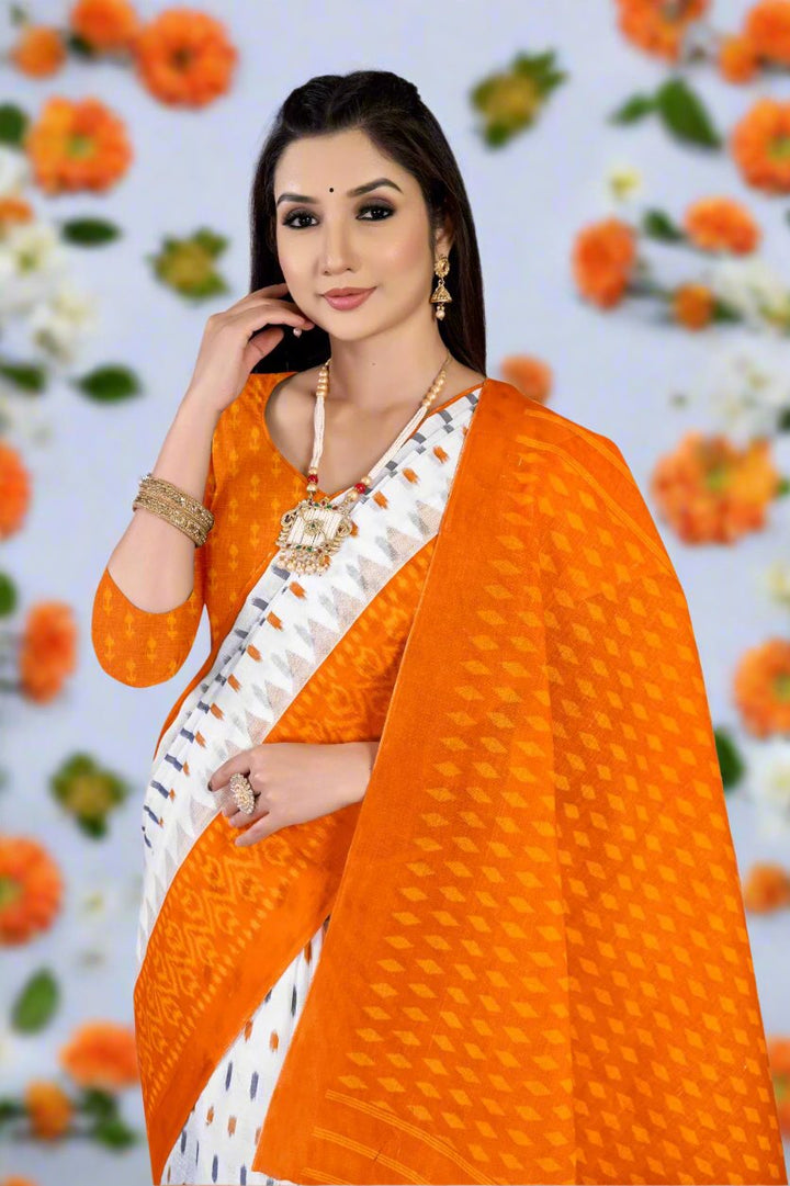 Gorgeous white and orange saree, crafted from cotton, ideal for vibrant celebrations.