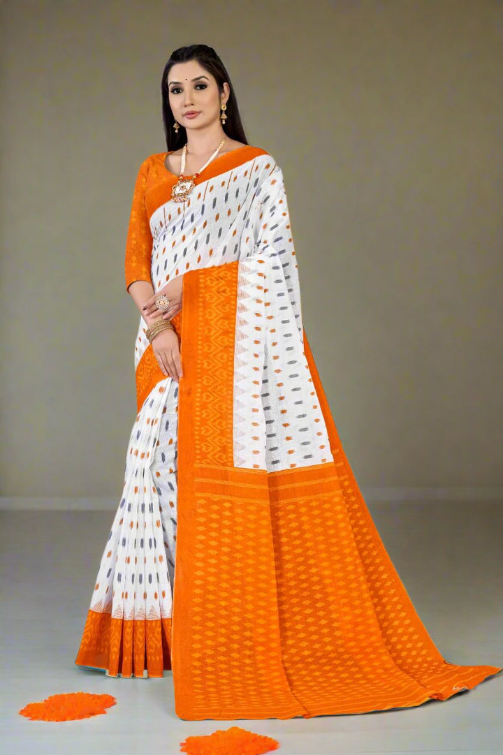 Graceful white and orange batik cotton saree, perfect for Indian festivals and celebrations.