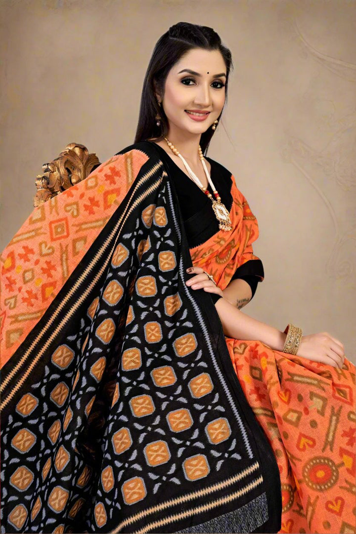 Traditional orange and black batik saree, perfect for cultural celebrations and weddings.