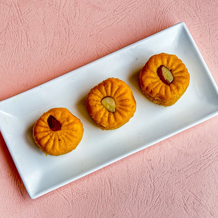 Kesar Peda, a saffron-infused milk sweet offering a smooth, melt-in-your-mouth texture, perfect for festive celebrations.