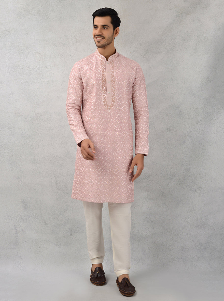 Celebrate in style with this luxurious rose pink kurta pajama featuring intricate embroidery.