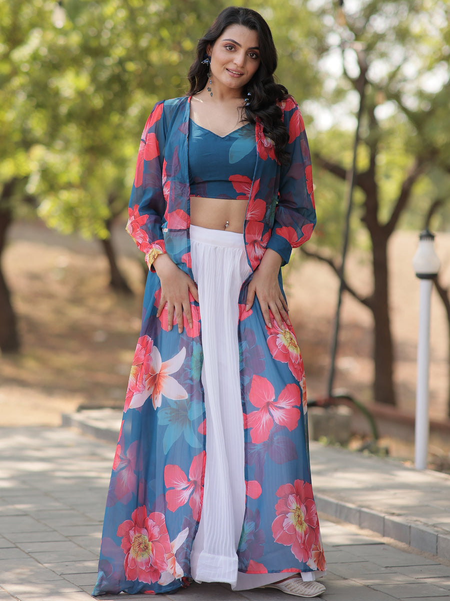 Make a graceful statement with this beautiful white georgette crush lehenga. Fully stitched and available in size L, the lehenga features a classic white fabric with a sophisticated textured finish.  The look is elevated by a sky-blue georgette crop top adorned with vibrant floral prints, adding a fresh and contemporary touch. Completing the ensemble is a sky-blue georgette jacket, also detailed with floral prints, which adds an extra layer of elegance.  Perfect for festivals, parties, or casual gatherings,