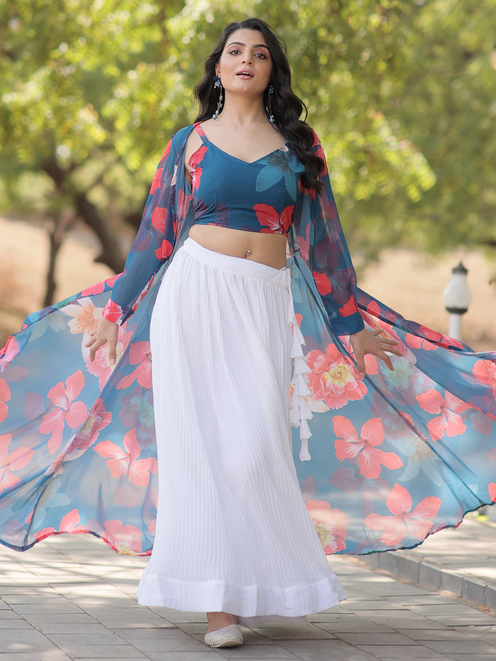 Make a graceful statement with this beautiful white georgette crush lehenga. Fully stitched and available in size L, the lehenga features a classic white fabric with a sophisticated textured finish.  The look is elevated by a sky-blue georgette crop top adorned with vibrant floral prints, adding a fresh and contemporary touch. Completing the ensemble is a sky-blue georgette jacket, also detailed with floral prints, which adds an extra layer of elegance.  Perfect for festivals, parties, or casual gatherings,