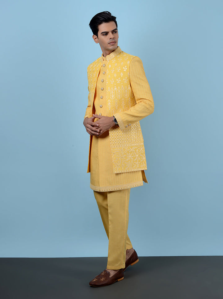 Embrace the festive spirit with this vibrant yellow Indowestern, designed for Haldi celebrations in the USA. Its luxurious silk blend and elegant embroidery add a stylish touch to your ethnic wear.