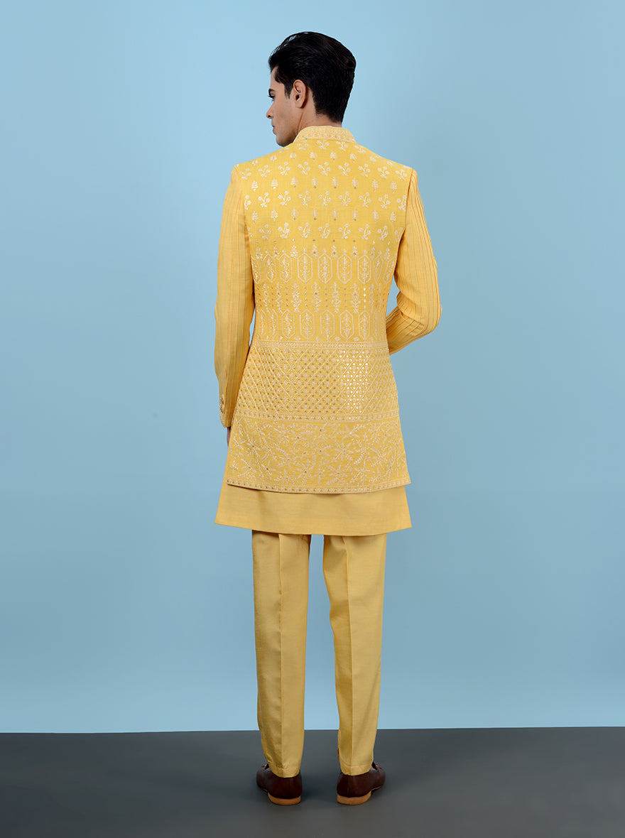 Elevate your Haldi celebration look in the USA with this vibrant yellow Indowestern, featuring luxurious silk blend fabric and intricate embroidery for a standout appearance.