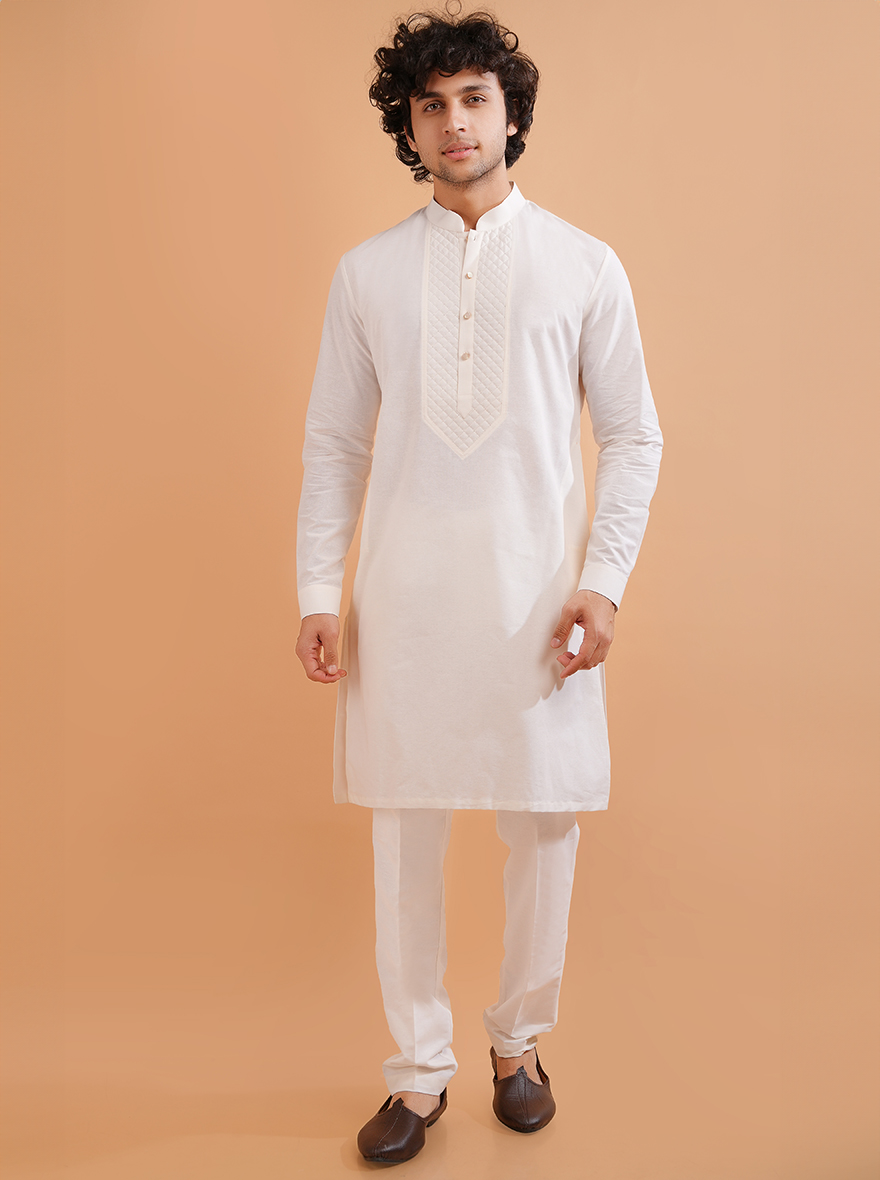 This white kurta pajama features delicate embroidery, adding charm and comfort to every occasion.