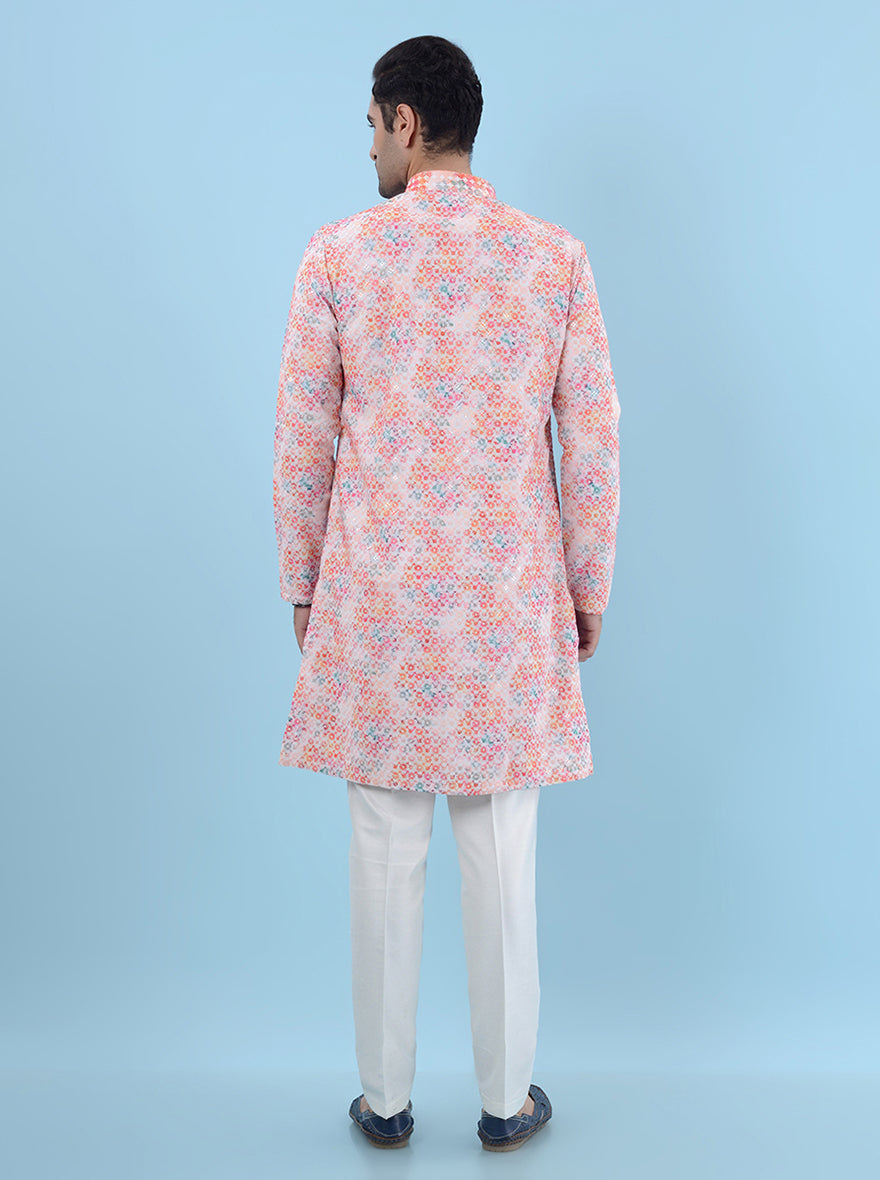 Stylish pink silk blend kurta pajama for men, featuring detailed embroidery for a festive look.