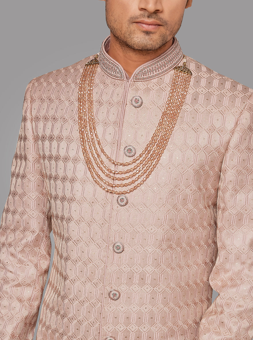 This onion pink silk sherwani features intricate resham and sequins embroidery for a stunning appearance.