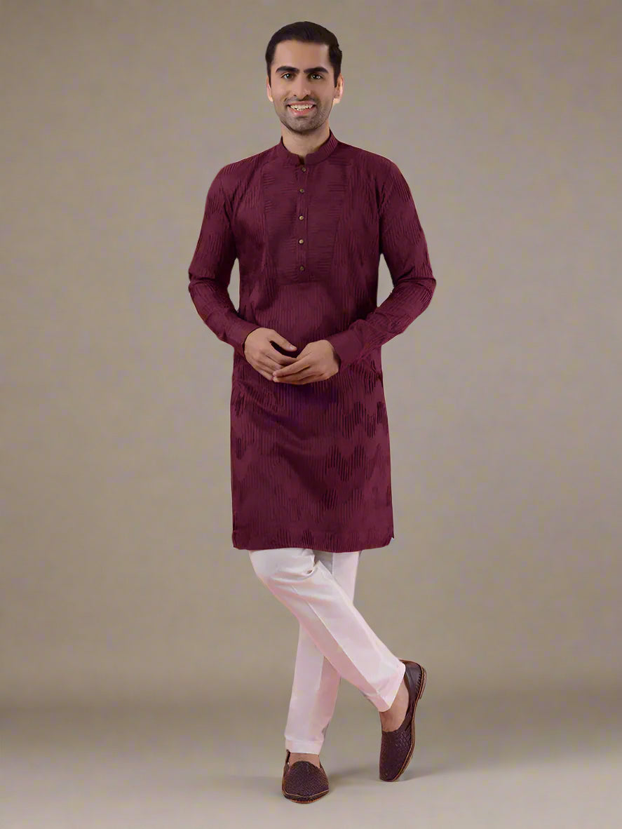 Men's wine silk kurta pajama set with detailed embroidery, ideal for cultural occasions.