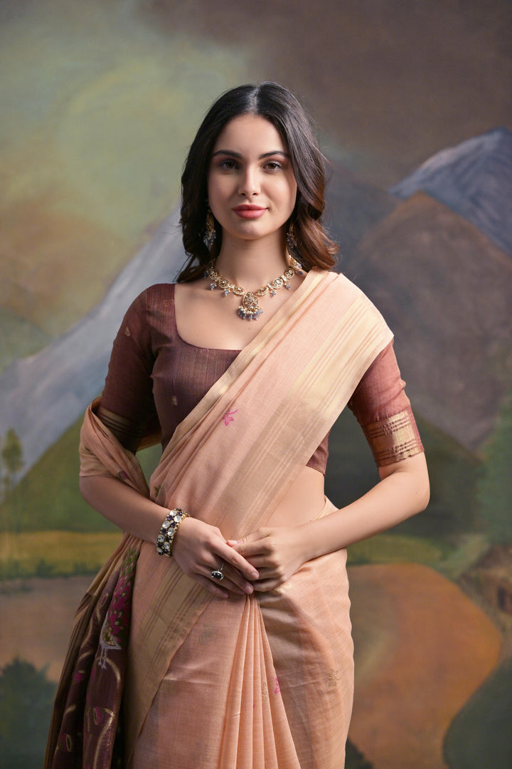 Beautiful peach Muga silk saree with fine Resham embroidery, ideal for weddings and special events.