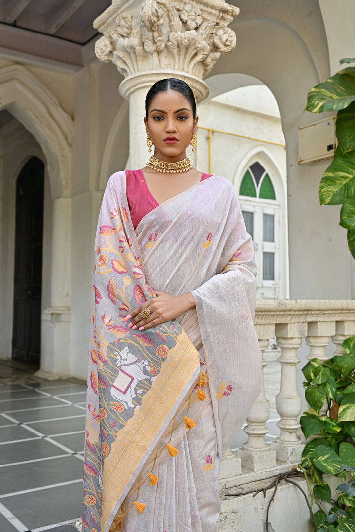 Elegant Muga silk saree with floral weaving, tassels, and contrast blouse