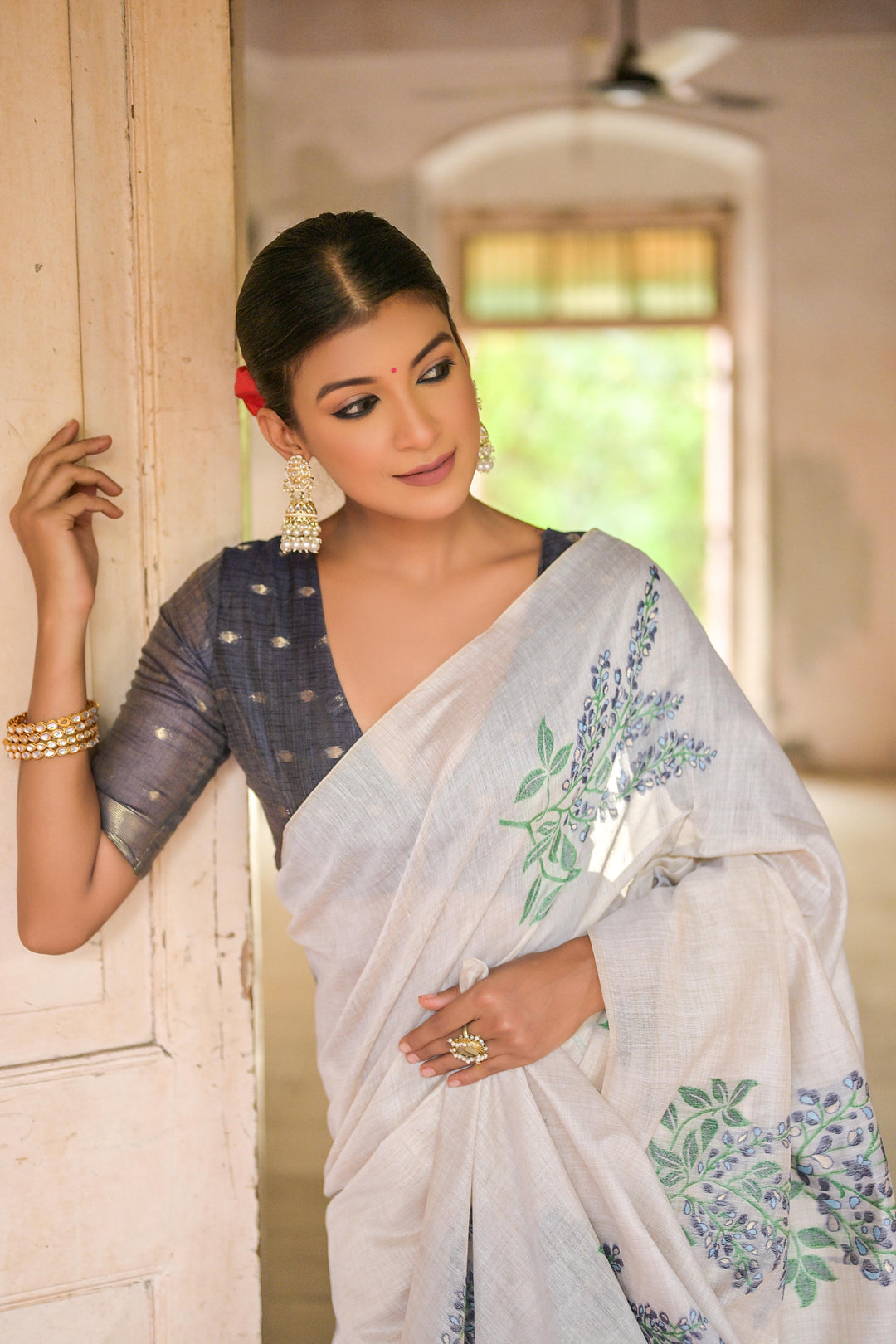 Elegant Muga cotton saree with floral weaving and small zari patta on pallu