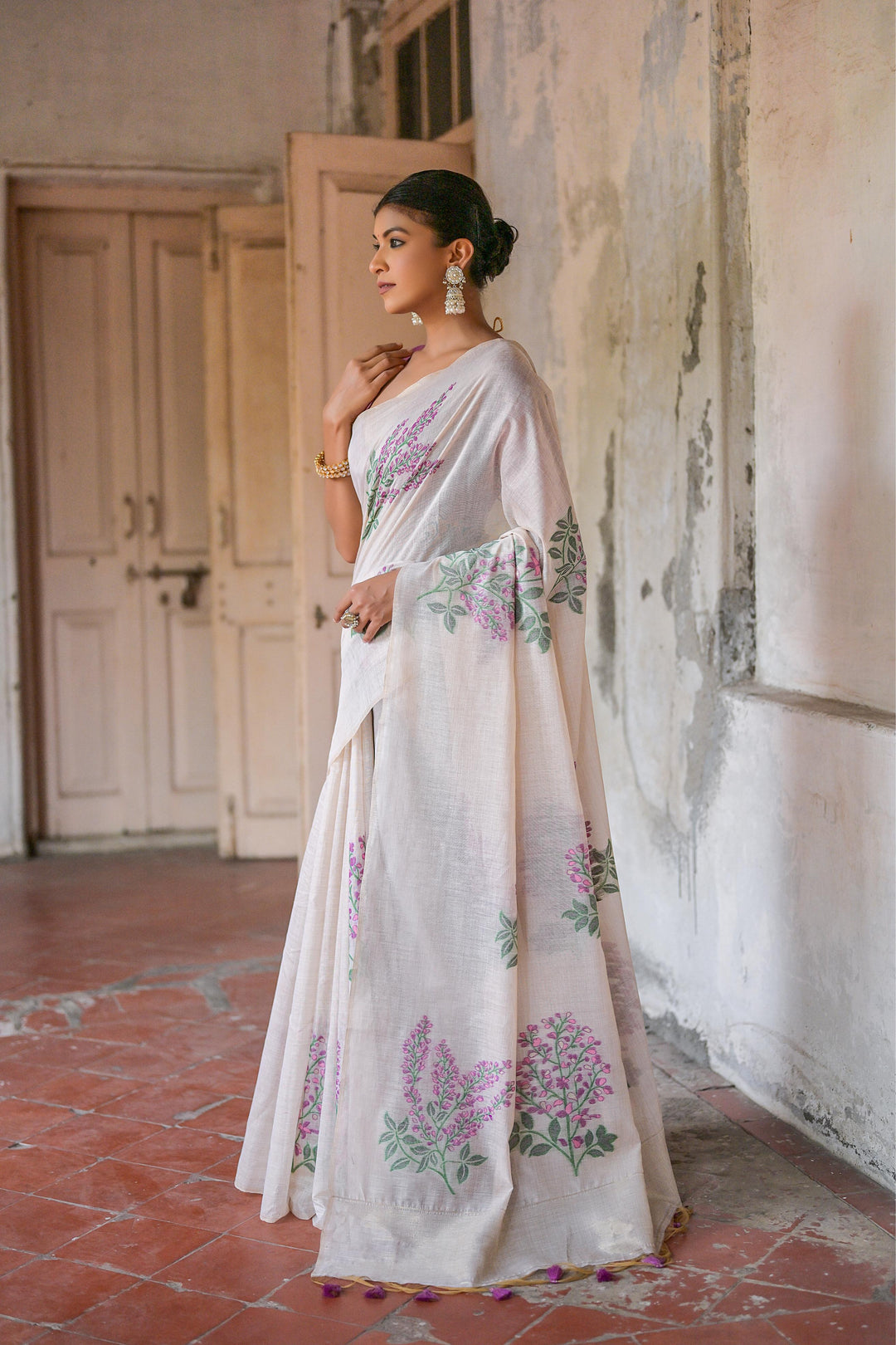 Exquisite floral pattern Muga saree with zari patta and tassels, crafted for festive elegance