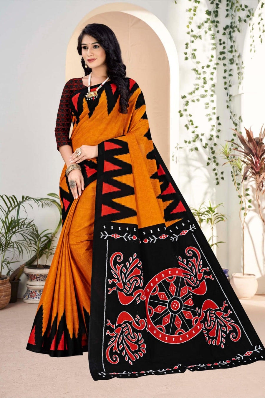 Elegant black and orange handloom cotton saree with intricate tribal art, perfect for weddings and festive occasions.