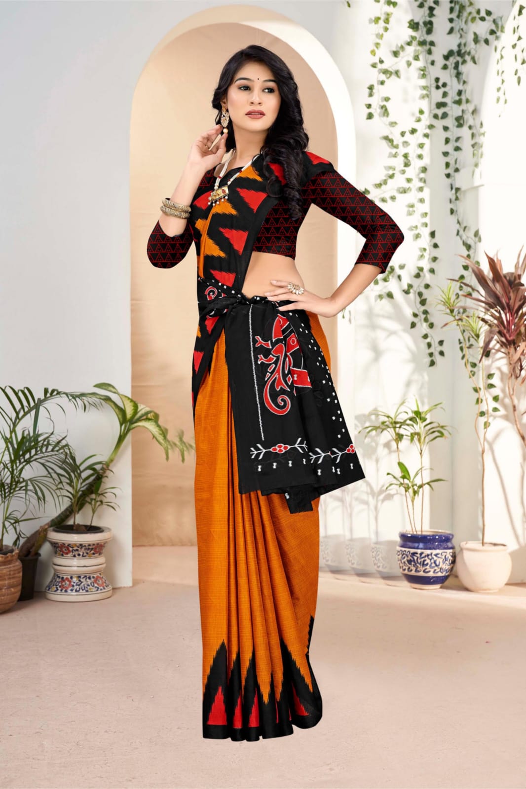 Traditional black and orange saree with unique tribal art, perfect for festive occasions.