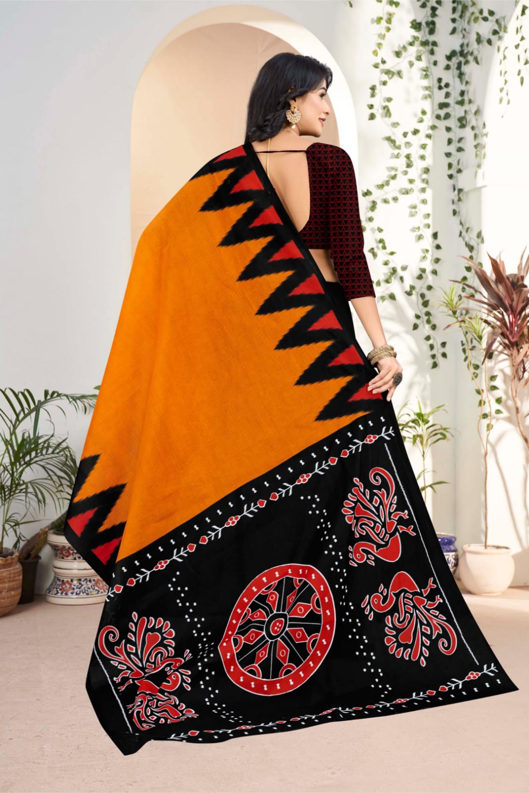 Beautiful black and orange handloom saree with artistic tribal motifs, perfect for weddings and celebrations.