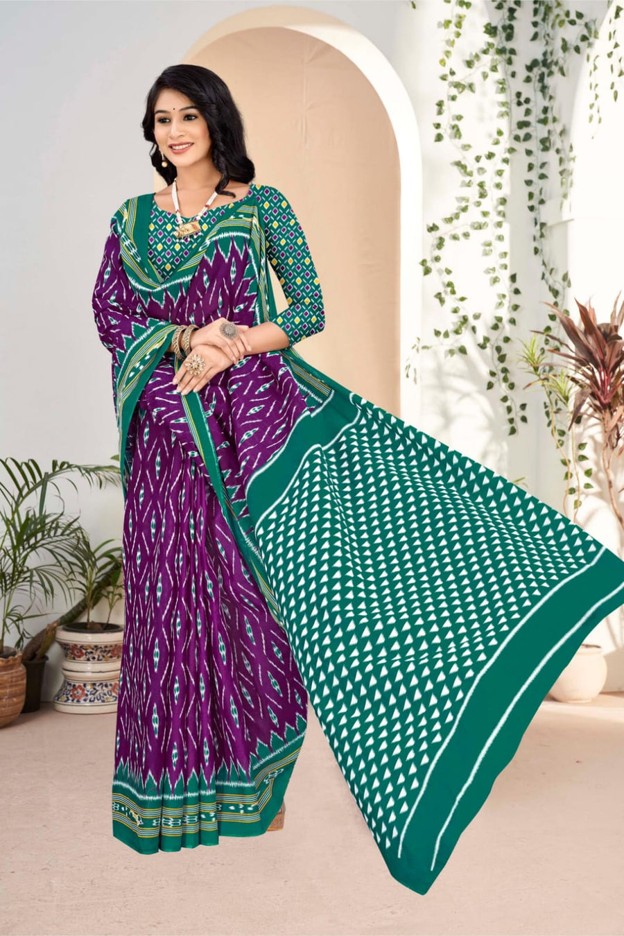 Elegant purple and pine green handloom cotton saree with tribal pattern, perfect for festive occasions.