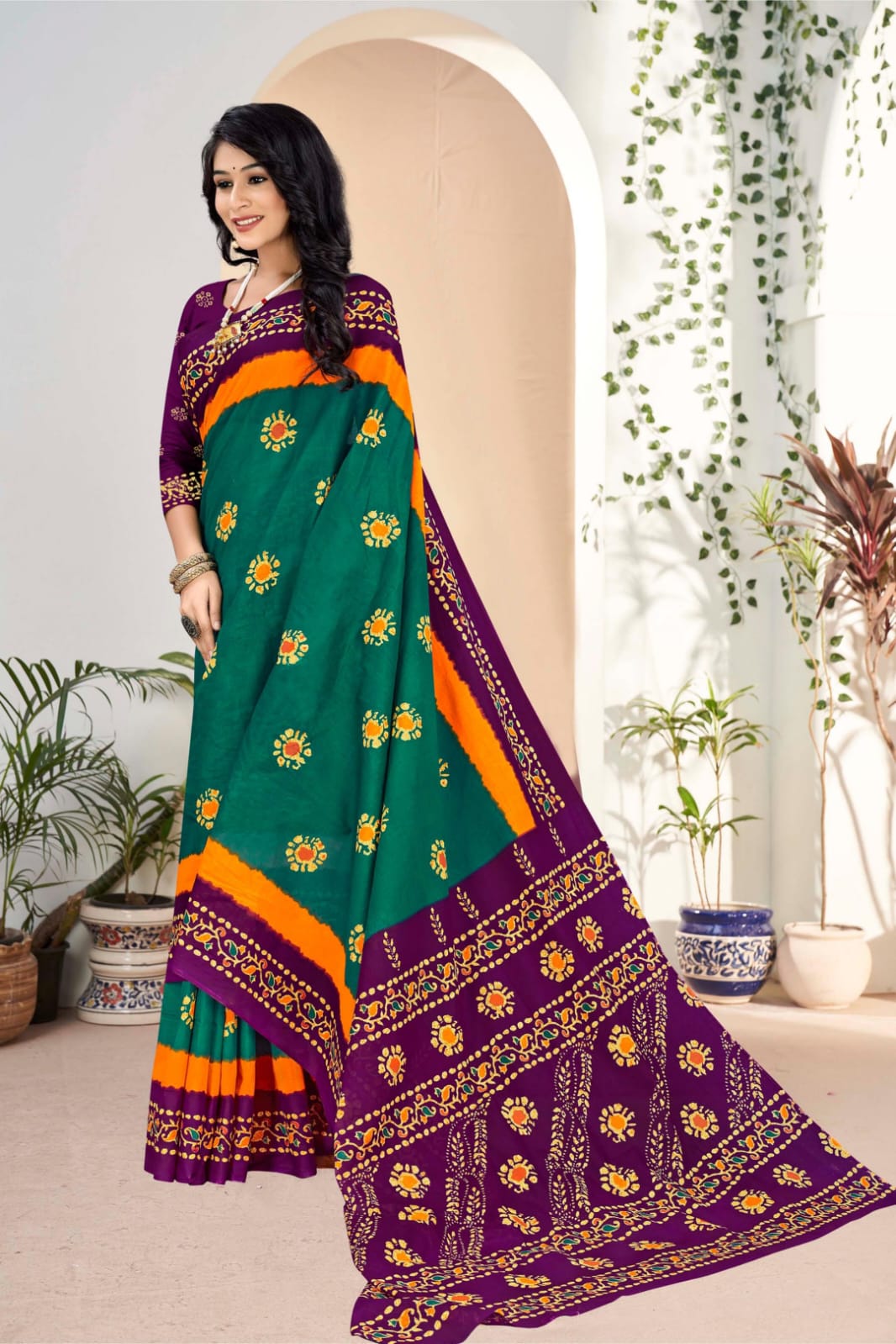 Elegant teal green and purple handloom cotton saree with intricate tribal designs, perfect for traditional celebrations.