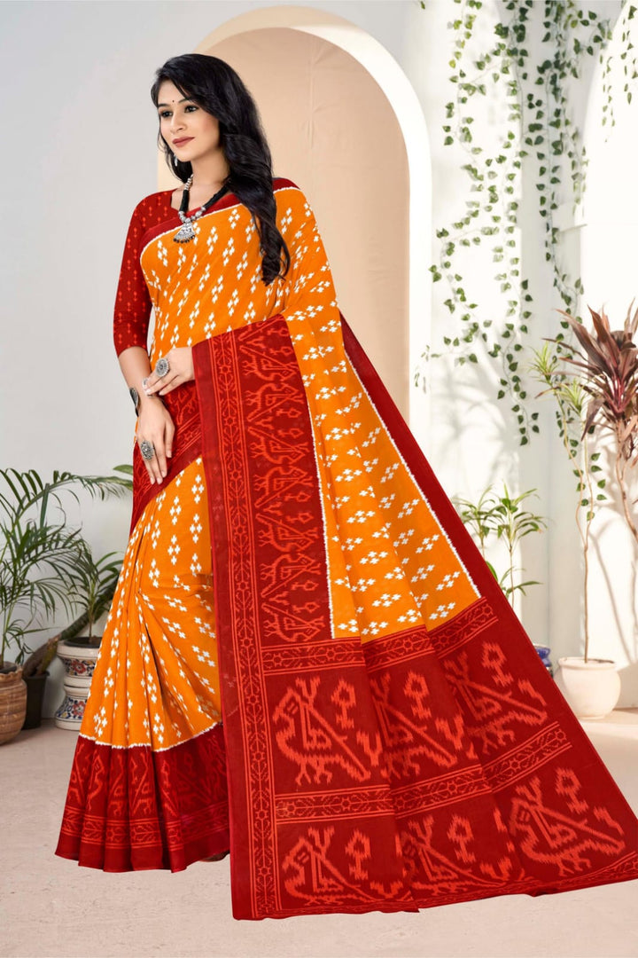 Stunning pumpkin and dark red handloom Indian saree with traditional tribal art, perfect for cultural events.