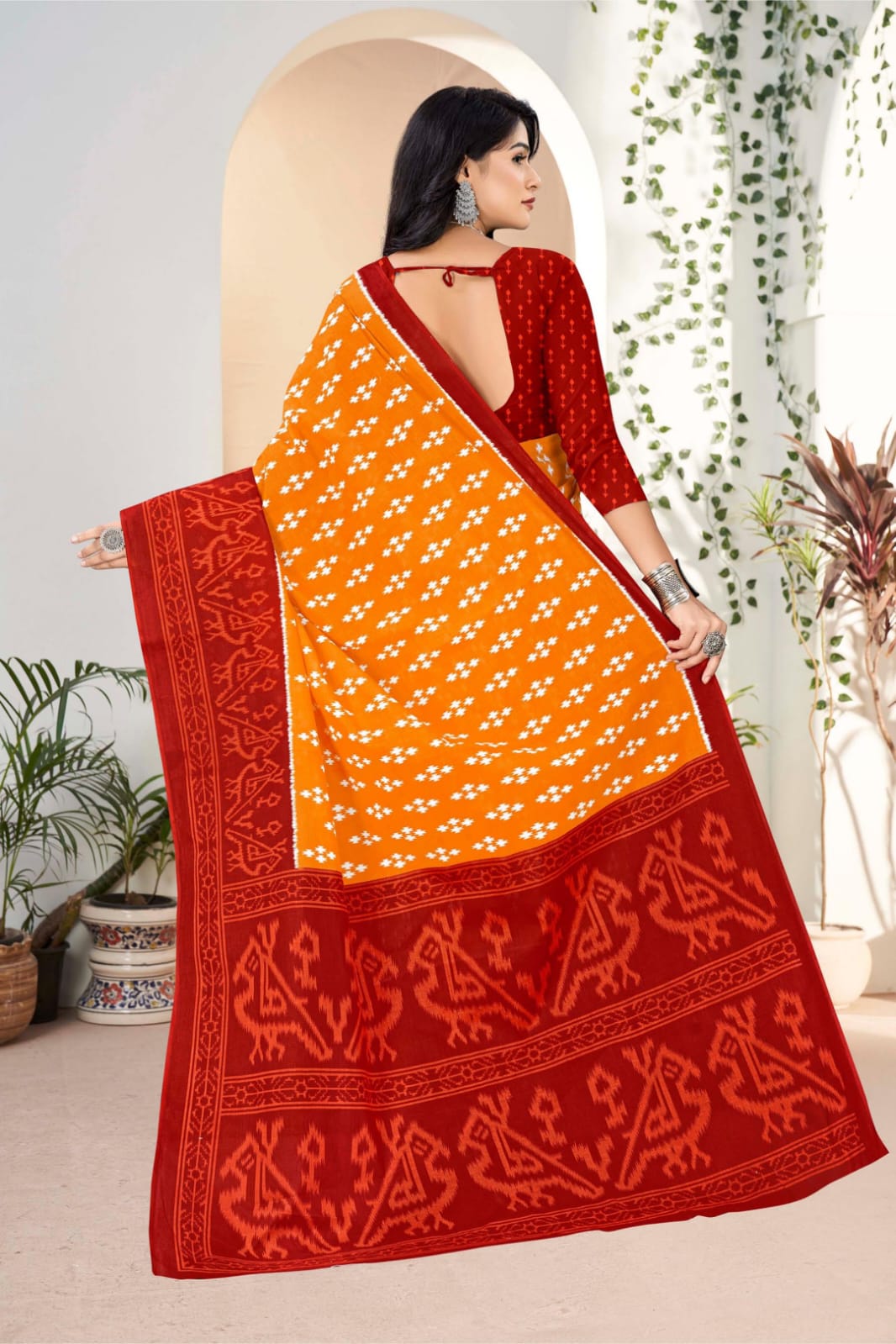 Traditional handloom Indian saree in pumpkin and dark red, featuring vibrant tribal art designs.