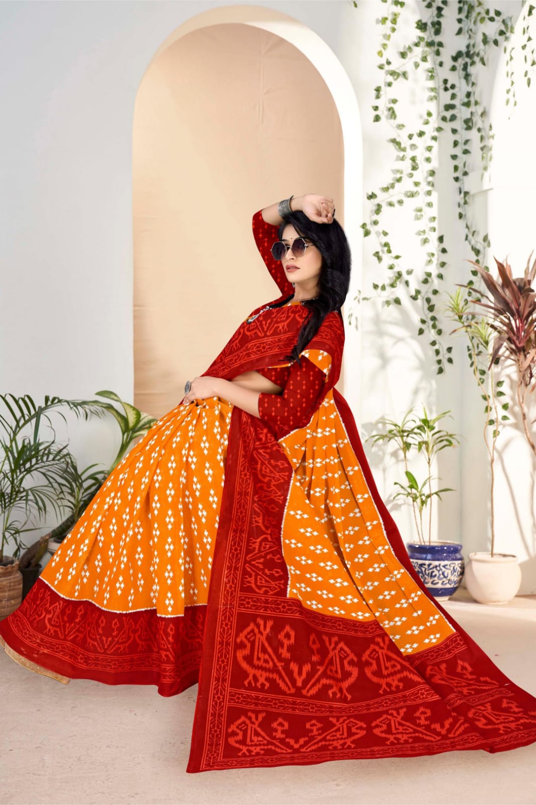 Rich pumpkin and dark red saree with traditional tribal art, perfect for Indian cultural celebrations.